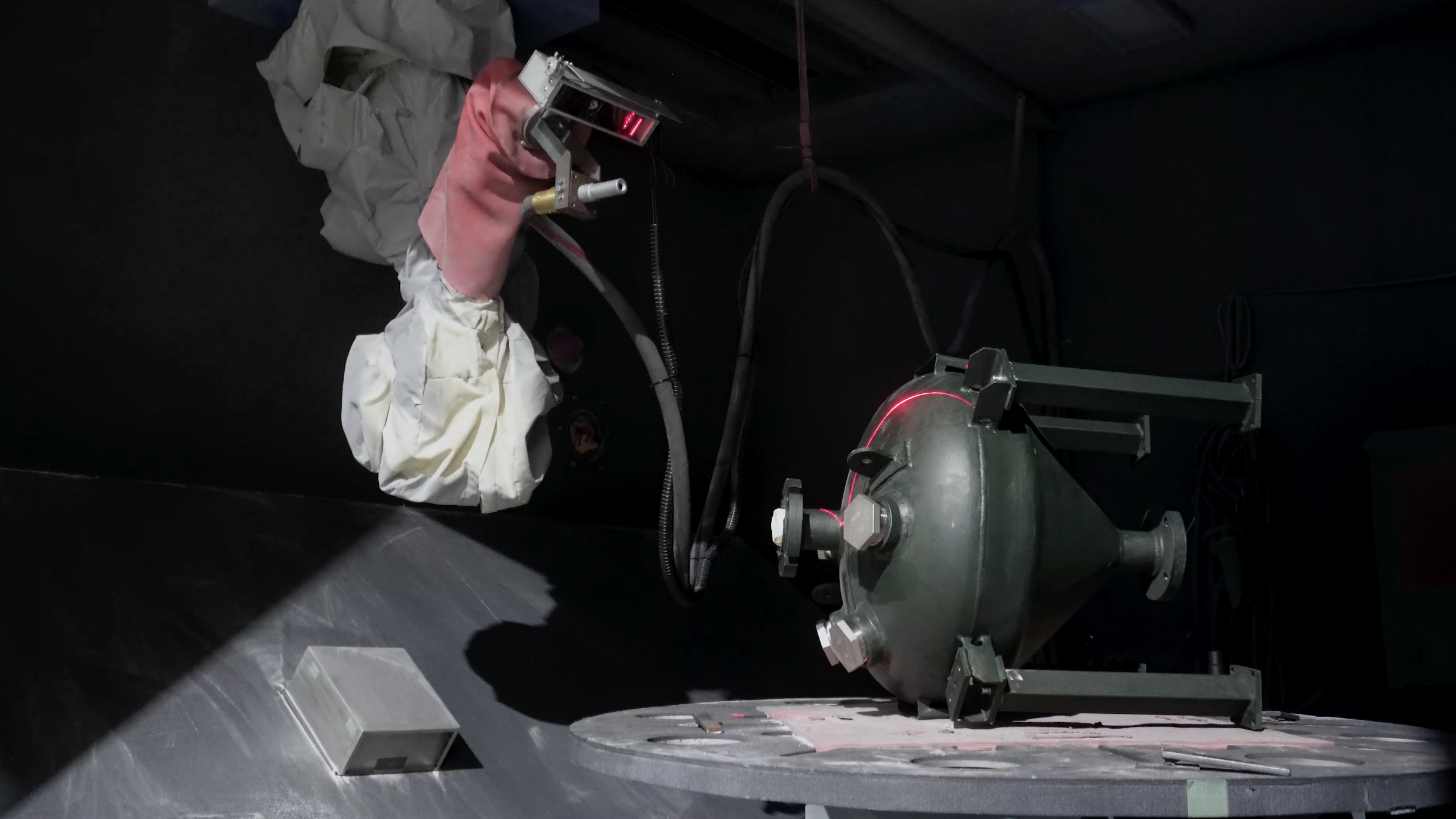 an image of a laser scanner attached to a robot arm, preparing a part for sandblasting