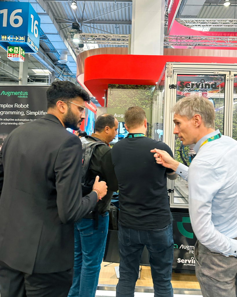 Members of Augmentus' sales team talking to booth visitors at Hannover Messe
