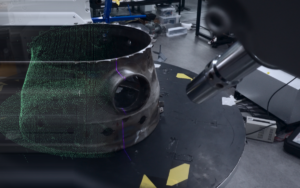 3D scanner capturing a continuous point cloud scan of a combustor casing on a turntable for automated toolpath planning